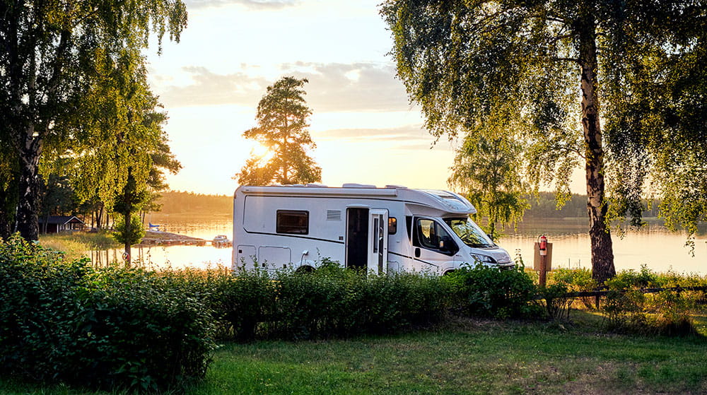 An image of a motorhome parked on a campsite.